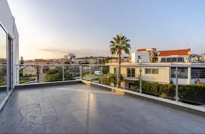 a large balcony with a view of a city at Penthouse with outdoor hottub in Limassol