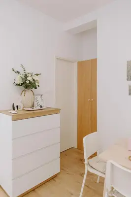 a white kitchen with a white dresser and a table at Stylish Stonehouse in Platres in Platres