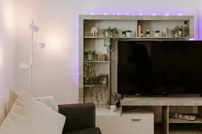 a living room with a flat screen tv on a shelf at Stylish Stonehouse in Platres in Platres