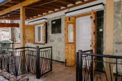 a porch with a door and a stone wall at Stylish Stonehouse in Platres in Platres