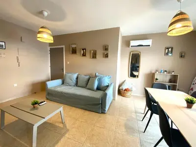 a living room with a couch and a table at 2Br Apt - 5mins walk to the Beach with Internet access in Larnaka