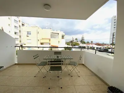 a table and chairs on a balcony with a view at 2Br Apt - 5mins walk to the Beach with Internet access in Larnaka