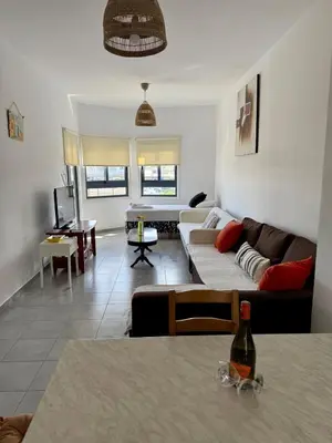 a living room with a couch and a table at Elena One Bedroom Budget Apt - License no 06991 in Paralimni