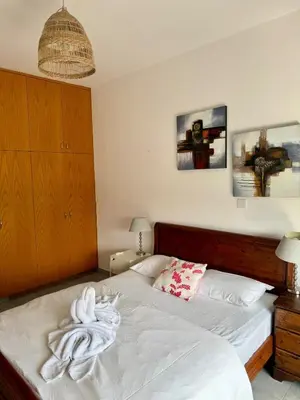 a bedroom with a bed with a towel on it at Elena One Bedroom Budget Apt - License no 06991 in Paralimni