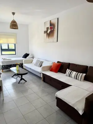 a living room with two couches and a table at Elena One Bedroom Budget Apt - License no 06991 in Paralimni