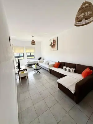 a living room with two couches and a table at Elena One Bedroom Budget Apt - License no 06991 in Paralimni