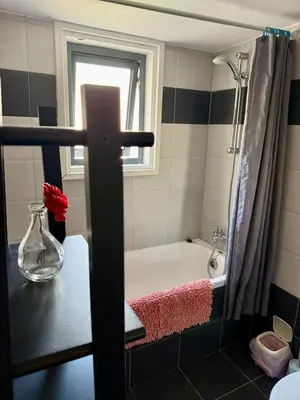 a bathroom with a bath tub and a window at Elena One Bedroom Budget Apt - License no 06991 in Paralimni
