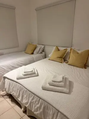 two beds with towels on top of them in a room at SWeET LEMON VILLA in Protaras