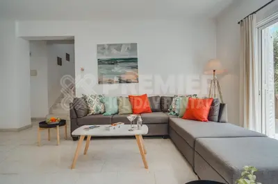 a living room with a couch and a table at Villa Andreas in Protaras