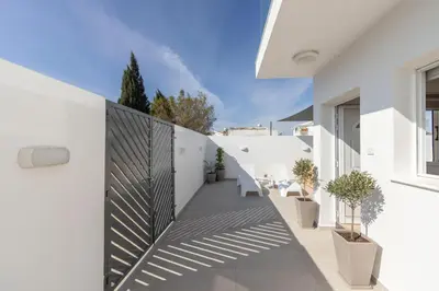 a white house with a courtyard with potted plants at Villa Antonieta in Ayia Napa