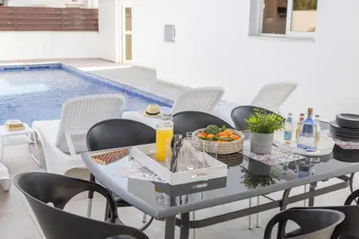 a dining room with a table with a bowl of fruit at Villa Antonieta in Ayia Napa