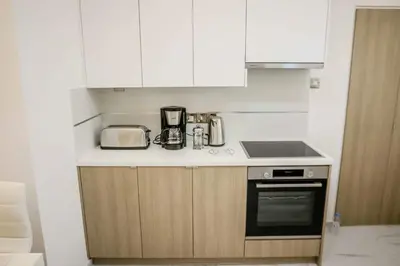 a kitchen with white cabinets and a counter top at Seaway moments in Limassol