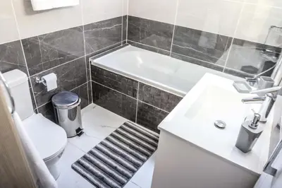 a bathroom with a toilet and a sink and a tub at Seaway moments in Limassol
