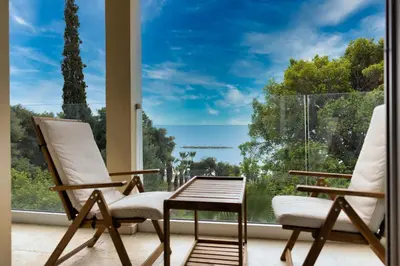 two rocking chairs sitting in front of a window at 3BR Beachfront Gem in Limassol in Limassol