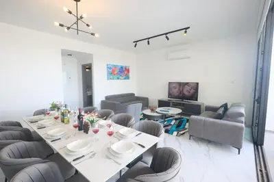 a dining room with a long table and chairs at Protaras Aqua Pearl Villa AQ12 in Paralimni