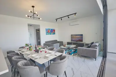 a dining room with a table and chairs at Protaras Aqua Pearl Villa AQ12 in Paralimni