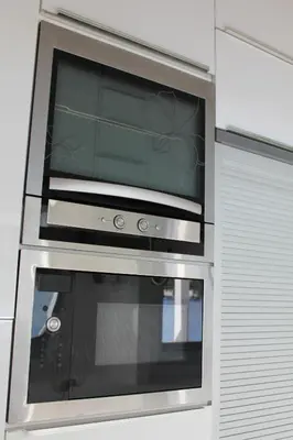 a microwave oven in a kitchen with a window at Marymina Villa in Protaras