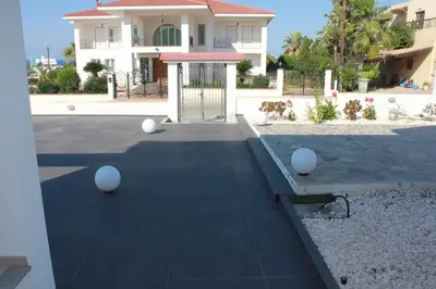 a house with a gate in front of a yard at Marymina Villa in Protaras