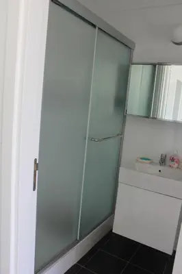 a glass shower in a bathroom with a sink at Marymina Villa in Protaras