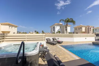 a backyard with a hot tub and a swimming pool at Villa Protaras View 6 Central Protaras -Fig Tree Bay-Jacuzzi-Hot Tub in Protaras
