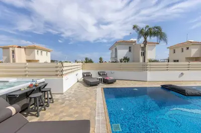 a backyard with a swimming pool and a villa at Villa Protaras View 6 Central Protaras -Fig Tree Bay-Jacuzzi-Hot Tub in Protaras