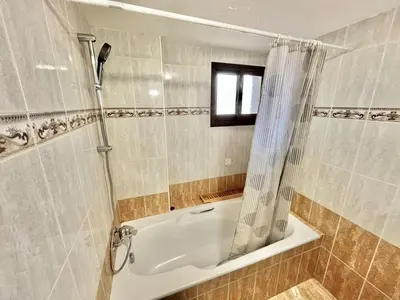 a bathroom with a shower and a bath tub at Spacious 3-Bedroom Apartment in Limassol in Limassol