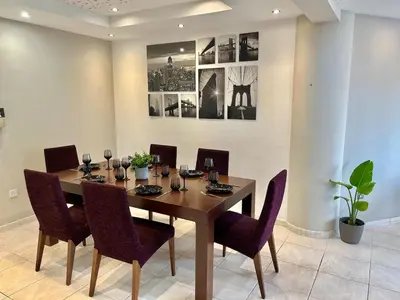 a dining room with a wooden table and chairs at Spacious 3-Bedroom Apartment in Limassol in Limassol