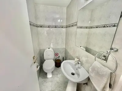 a small bathroom with a toilet and a sink at Spacious 3-Bedroom Apartment in Limassol in Limassol