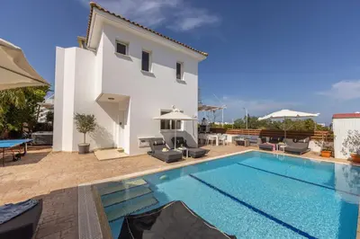 a swimming pool in front of a villa at Villa Protaras View 9 Central Protaras -Fig Tree Bay-Jacuzzi-Hot Tub in Protaras