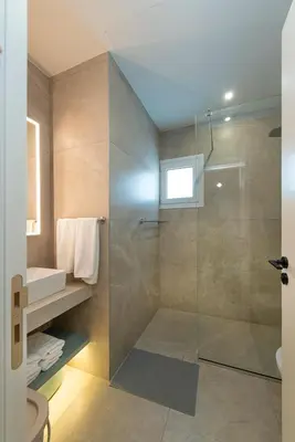 a bathroom with a shower with a glass door at Amore Protaras Apartments in Paralimni