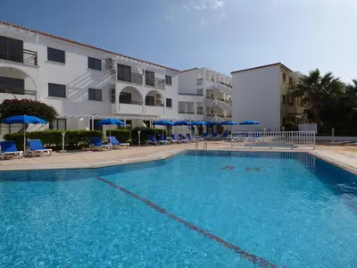 a large swimming pool in front of a building at Amore Protaras Apartments in Paralimni