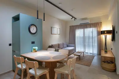 a living room with a table and a couch at Amore Protaras Apartments in Paralimni