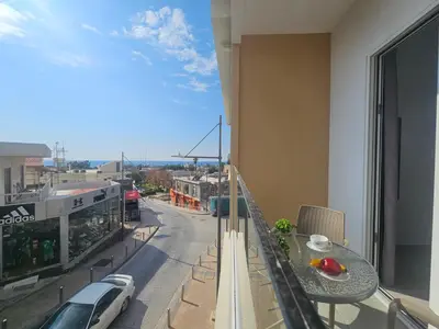 a balcony with a table and a view of a street at Piazza Napa Studio Apts self serviced in Ayia Napa