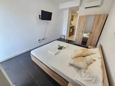 a bed with two pillows on it in a room at Piazza Napa Studio Apts self serviced in Ayia Napa