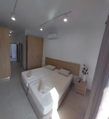 a bedroom with a large white bed in a room at Piazza Napa Studio Apts self serviced in Ayia Napa