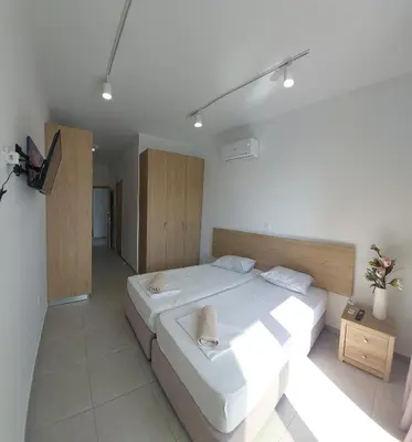 a bedroom with a large white bed in a room at Piazza Napa Studio Apts self serviced in Ayia Napa