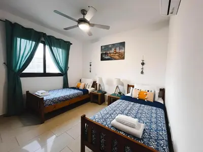a bedroom with two beds and a ceiling fan at Déjà Blue Apartment Kyklades BC7 - workspace, pool, gym, nearby beach in Protaras