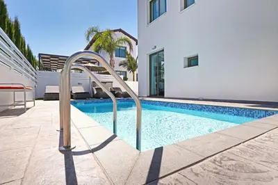 a swimming pool with a stairway leading to a house at Villa Jasmin - 4Bed with Private Pool in Paralimni