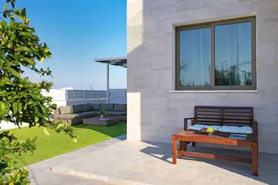 a bench sitting on the side of a house at Villa Jasmin - 4Bed with Private Pool in Paralimni
