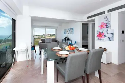 a living room with a dining room table and chairs at Apartment Marisol - Beachfront in Protaras