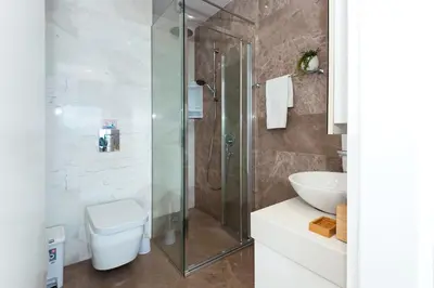a bathroom with a shower and a toilet and a sink at Apartment Marisol - Beachfront in Protaras