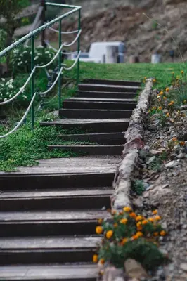 a set of stairs in a park with flowers at Private Glamping Cabin for Family Getaway with BBQ in Arakapas