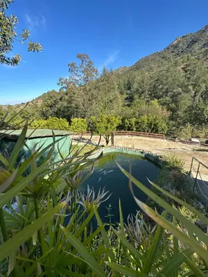 a pool of water with mountains in the background at Private Glamping Cabin for Family Getaway with BBQ in Arakapas