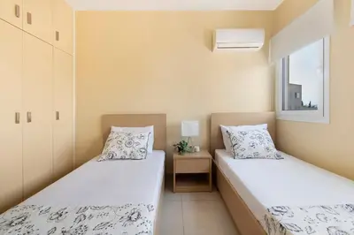 two beds in a small room with a window at City Center, Nice View, 2BR in Larnaka
