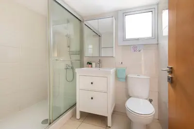 a bathroom with a toilet and a glass shower at City Center, Nice View, 2BR in Larnaka