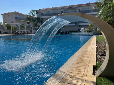 a water fountain in a swimming pool at Mythical Sands Resort, Protaras, Choose Joy Apt in Paralimni