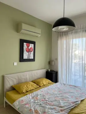 a bedroom with a bed and a large window at Limassol Star Complex Seaview Apartment in Limassol