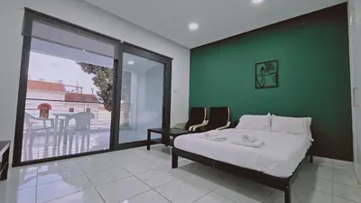 a bedroom with a bed and a green wall at STAY Cypress Studio in Limassol