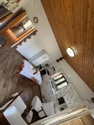 an overhead view of a kitchen with white chairs at Little Paradise in Sotira