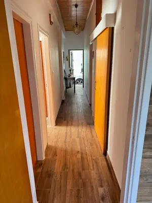 a hallway in a house with wood floors at Little Paradise in Sotira